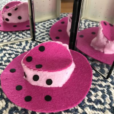 pink hat with polka dots reflected in multiple mirrors