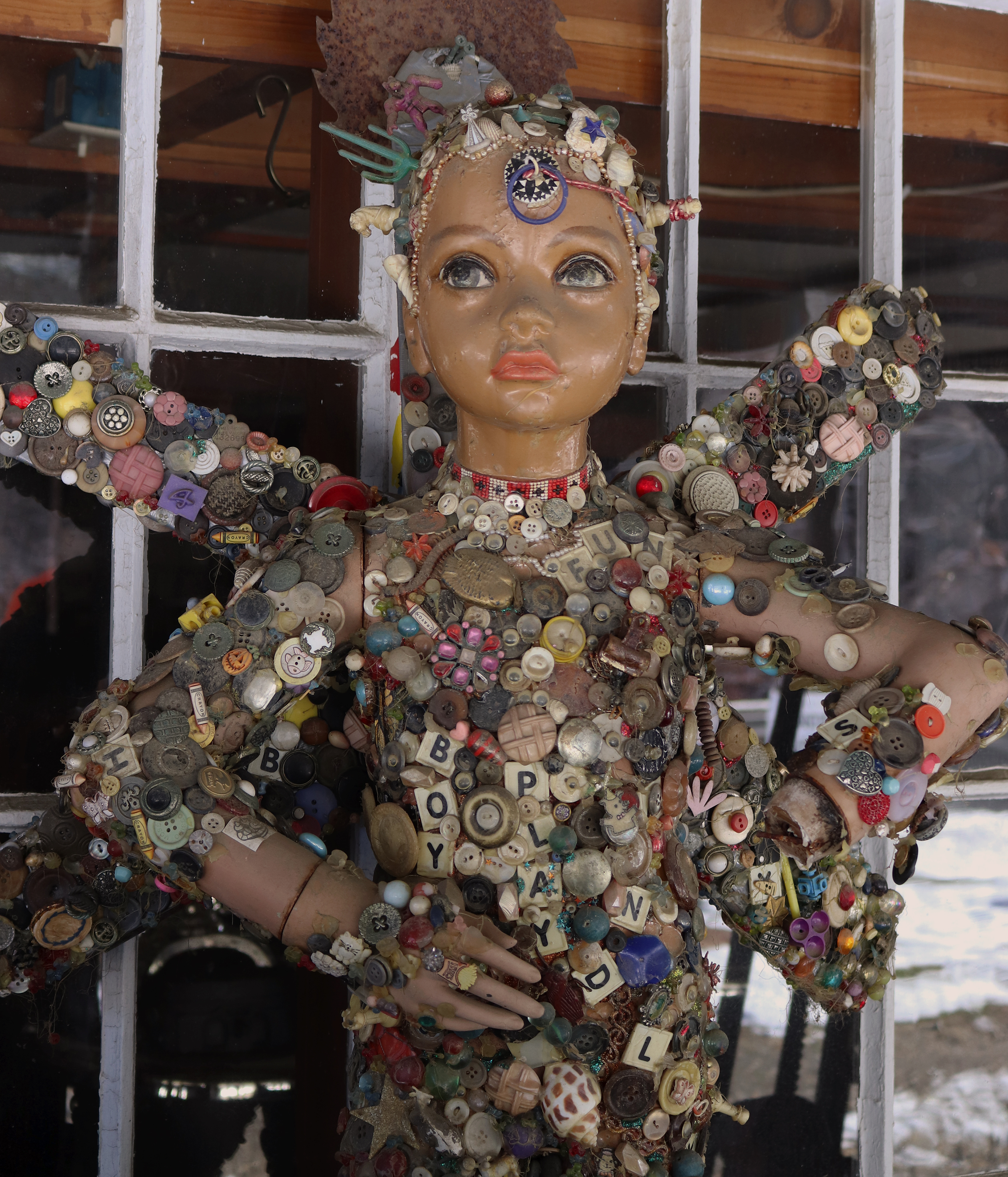 Doll covered in letters & buttons